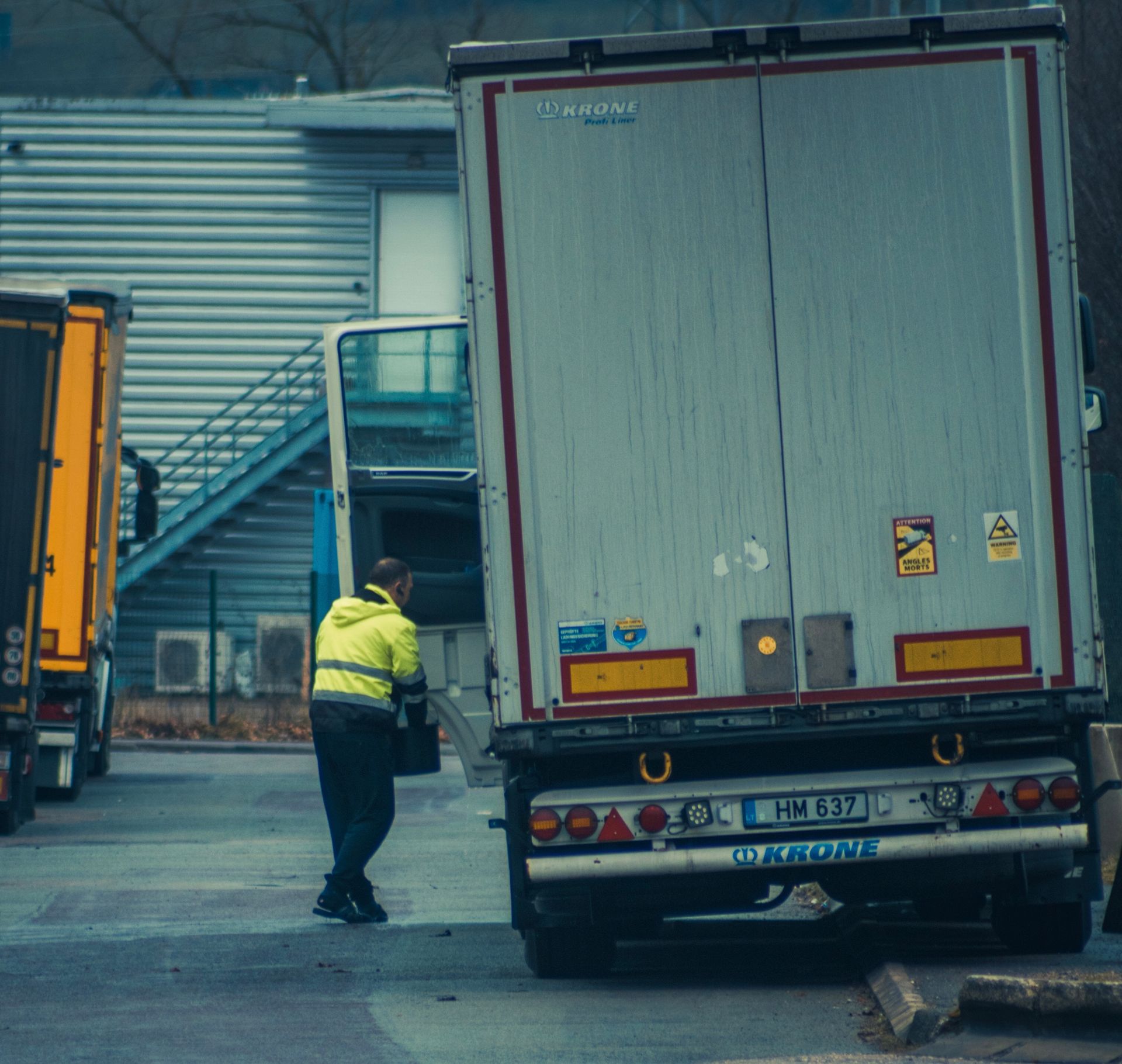 Truck driver securing cargo on a European highway rest stop