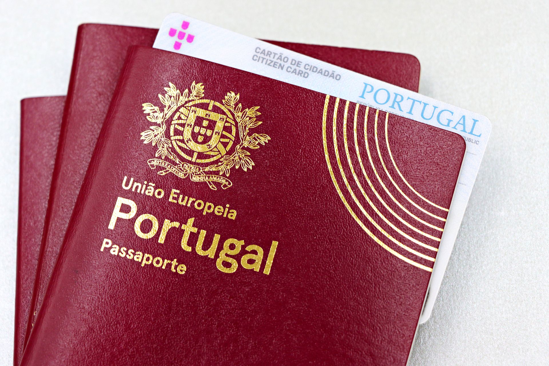 EU long-term residence permit card and passport on a desk