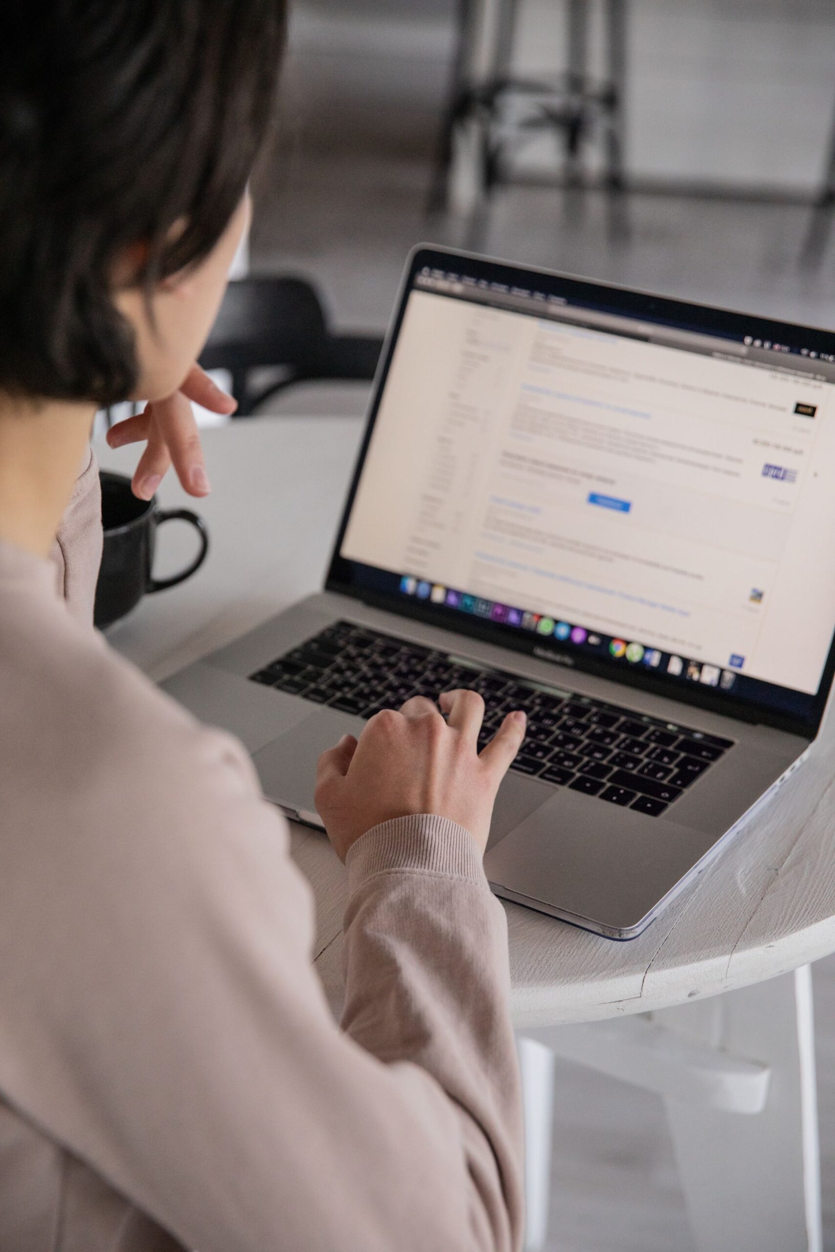 Job seeker researching visa-sponsored jobs on a laptop